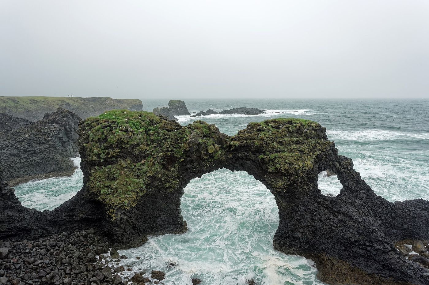 The Gatklettur stone arch in the surf at Arnarstapi