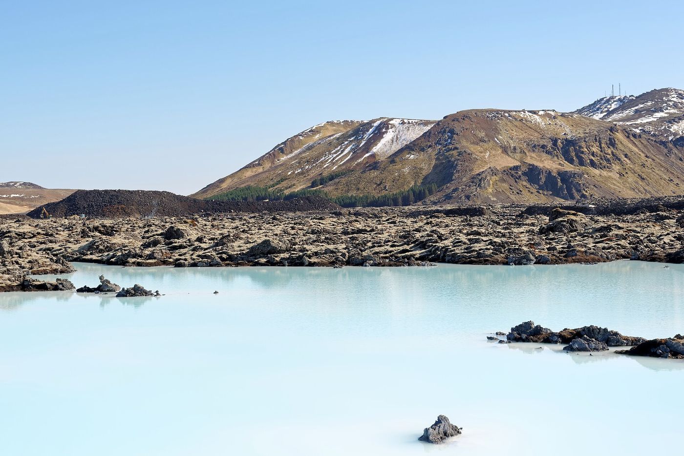 The milky-blue water of the Blue Lagoon in its black lava field