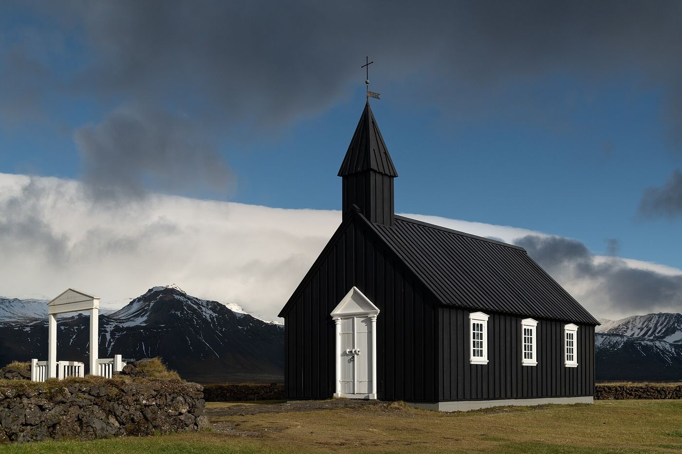 The black church of Búðir beneath the mountains