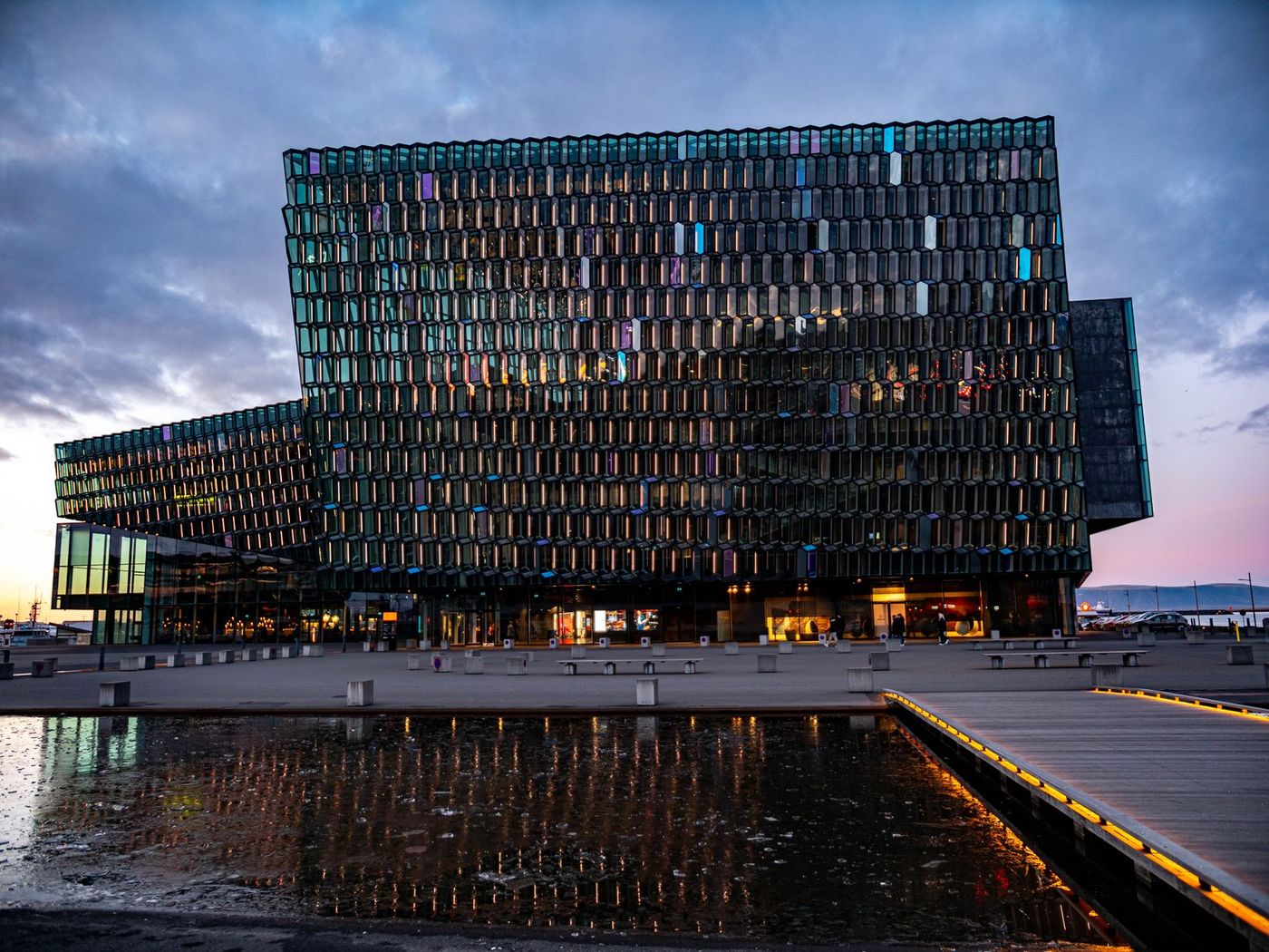 Harpa concert hall's honeycomb glass facade glowing at dusk