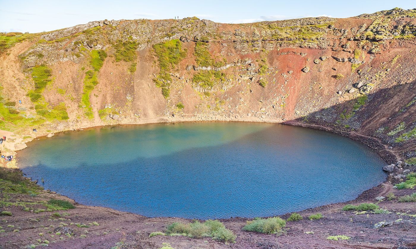 Kerið crater's red slopes around its teal lake
