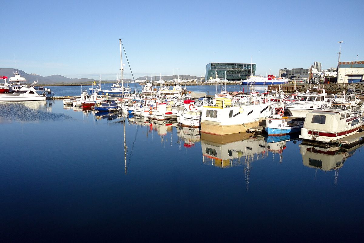 Boats in Reykjavík's old harbour with Harpa behind