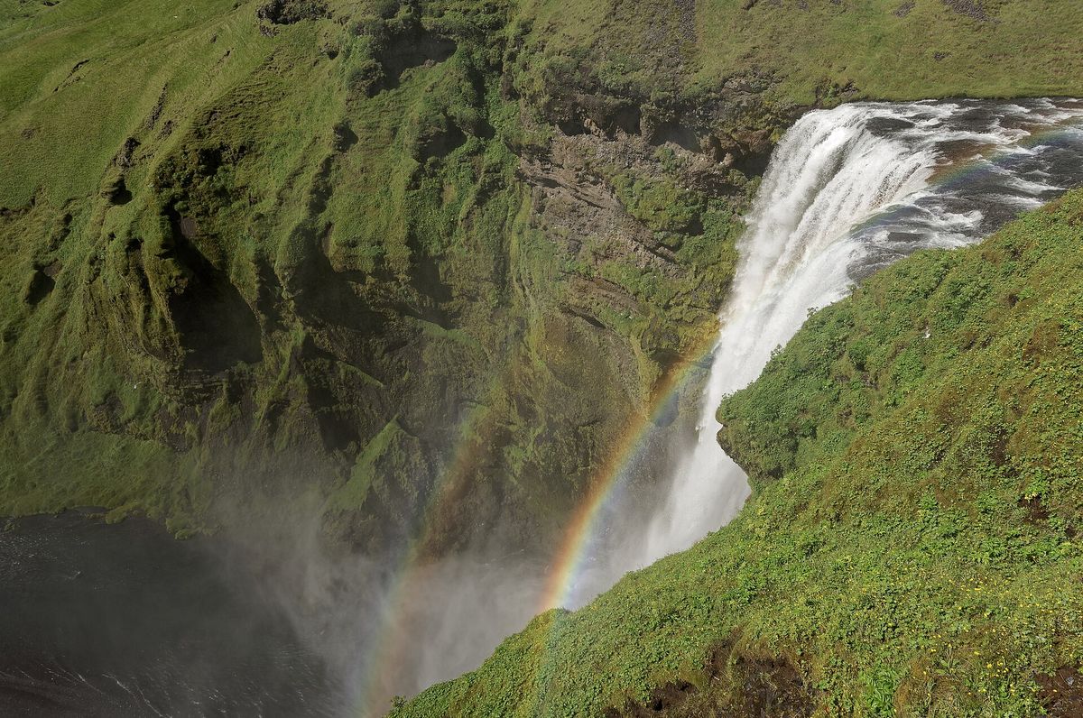 A rainbow in the spray at Skógafoss, seen from the clifftop