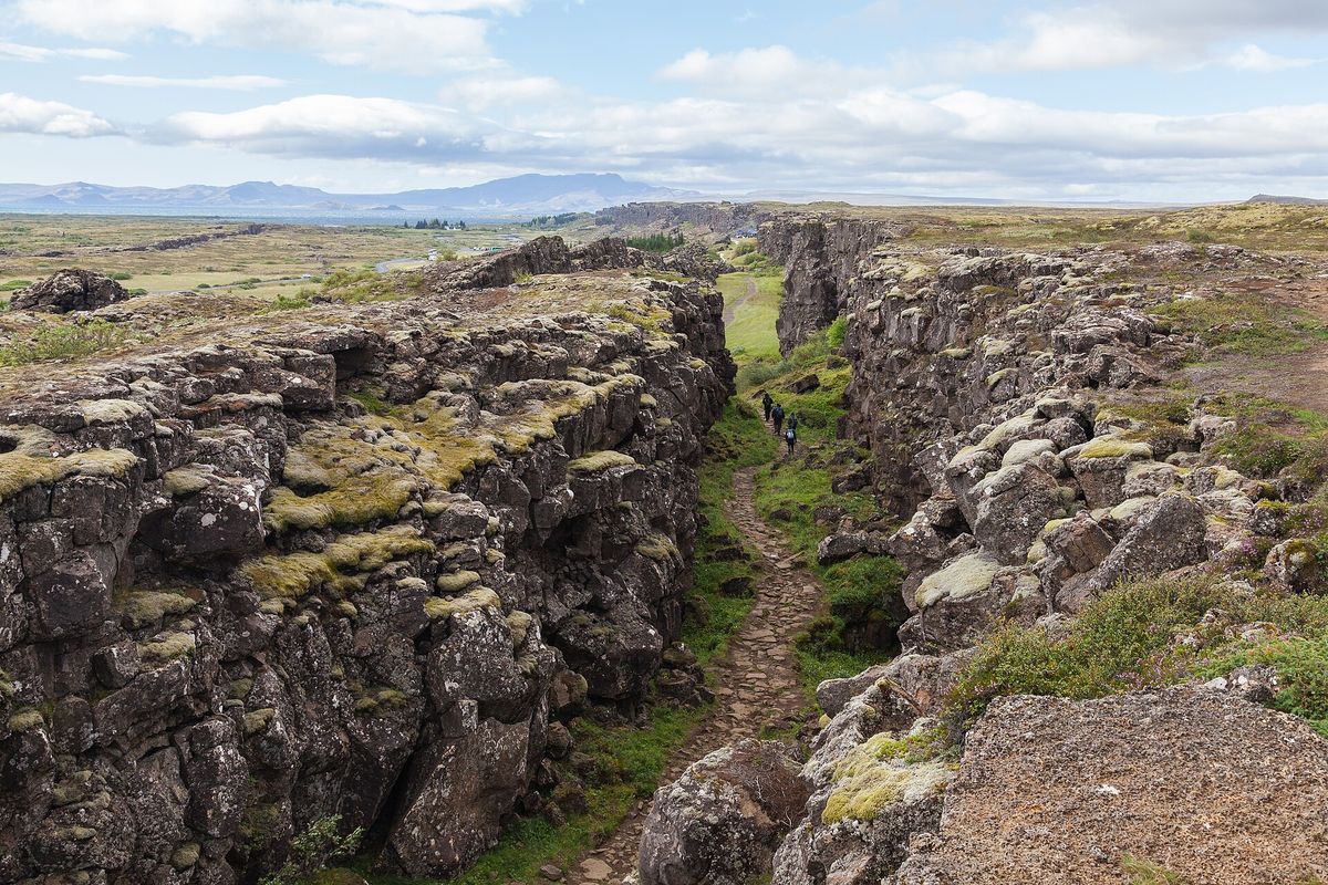 The rift-valley path winding between mossy walls of rock at Þingvellir